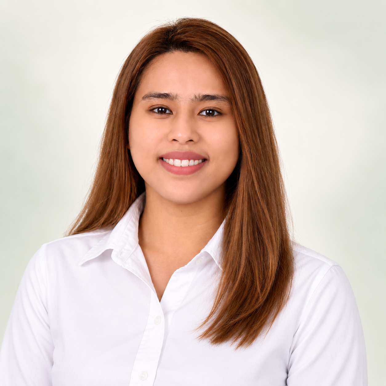 Inds smiling in a white collared shirt against a soft ivory and sage background